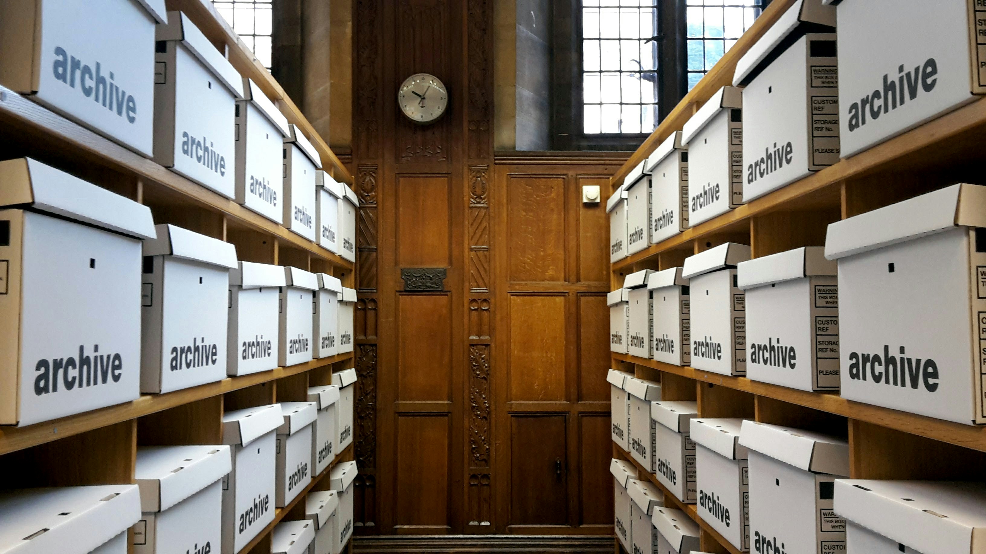 Shelves lined with bankers boxes of archived files